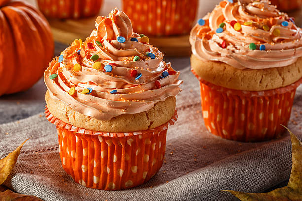istock Pumpkin cupcakes with glitter sugar sprinkles. 619067656