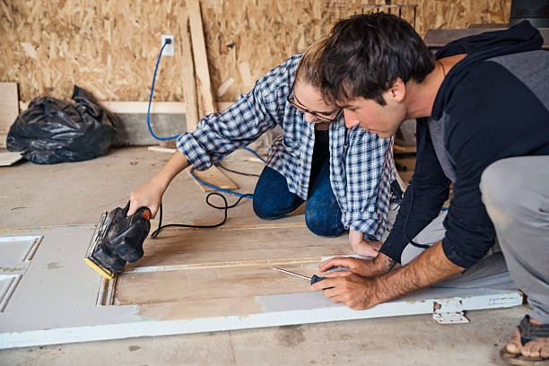 istock DIY for young couple sanding down door in a shed. 619067660