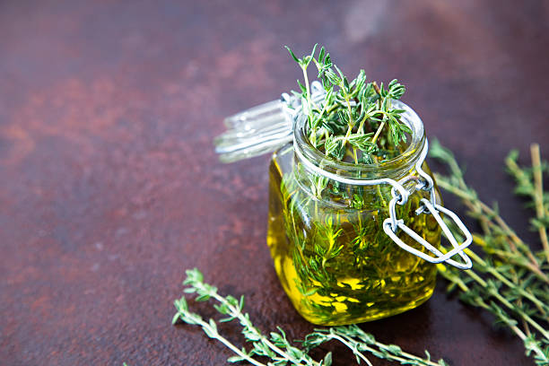 istock Thyme oil. Thyme essential oil jar glass bottle 619067752