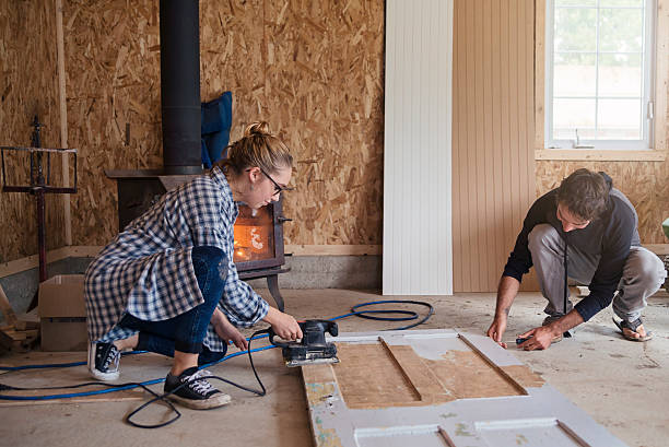 istock DIY for young couple sanding down door in a shed. 619068720
