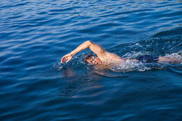 istock Man swimming in blue water 619068886