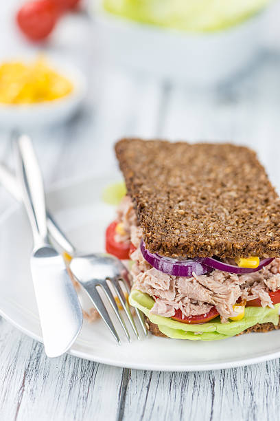 istock Wooden table with Tuna sandwich (on wholemeal bread; selective f 619069272