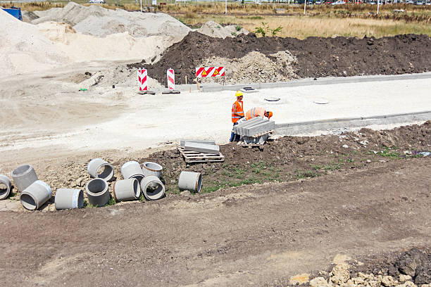 Road works. Zrenjanin, Vojvodina, Serbia - August 3, 2015: Building activities during construction of the large complex shopping mall "AVIV PARK" in Zrenjanin city.  kerbstone stock pictures, royalty-free photos & images