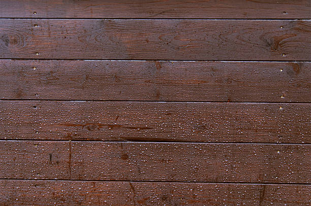 Old dark wooden wall with raindrops background texture close up