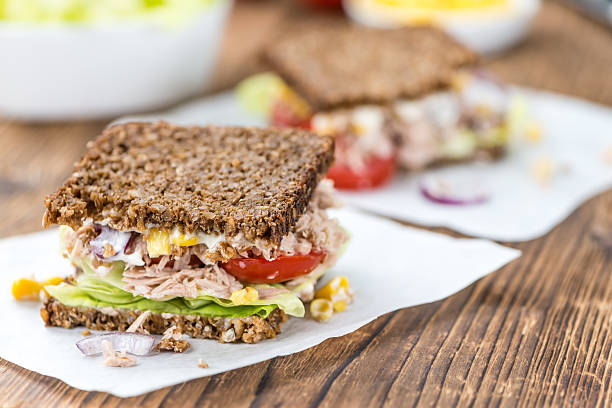 istock Wooden table with Tuna sandwich (on wholemeal bread; selective f 619072158