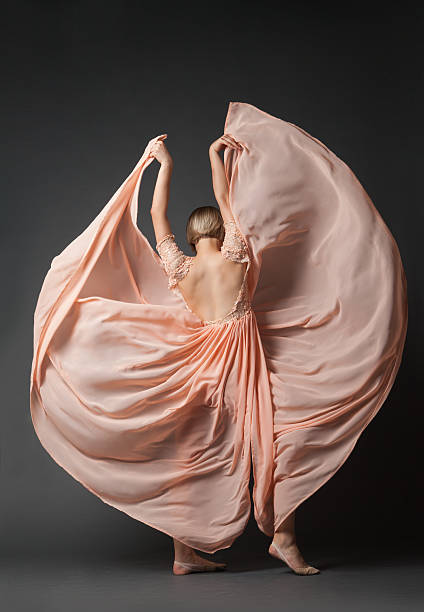 istock Woman dancing in light dress 619072180