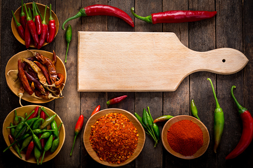 Chili peppers on the wooden background 