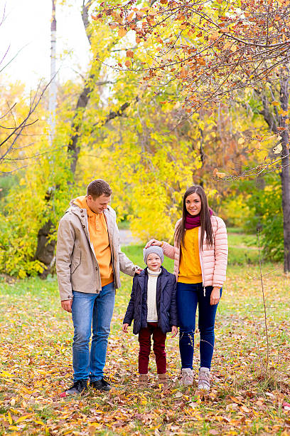 istock Family walks in the autumn park 619072508