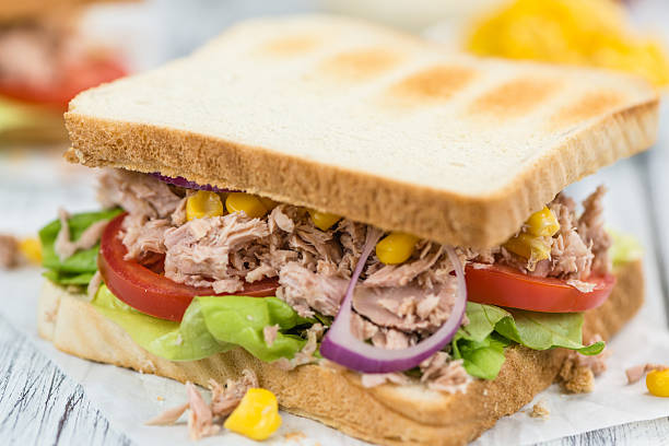 istock Wooden table with a Tuna Sandwich (selective focus) 619072556