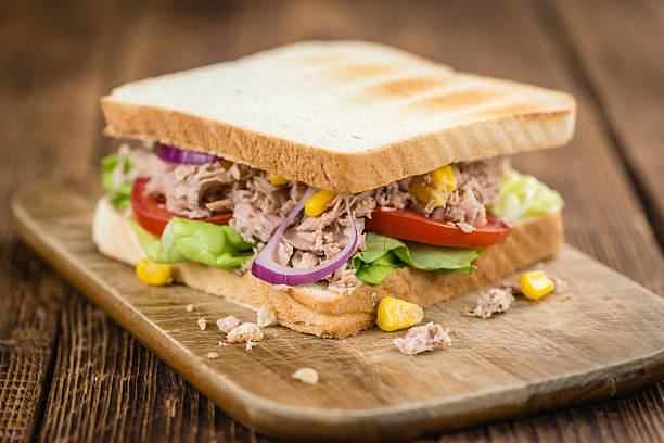 istock Wooden table with a Tuna Sandwich (selective focus) 619074636