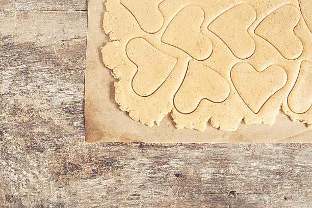 istock Roll out the dough to cut out heart shapes 619075430