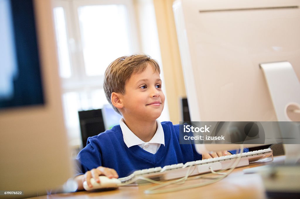 School boy learning computer programming School boy coding in a computer lab at school. Child Stock Photo