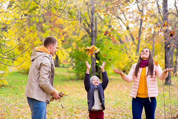 istock family playing with leaves autumn park 619076644