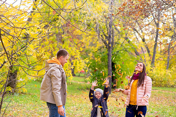 istock family playing with leaves autumn park 619077074