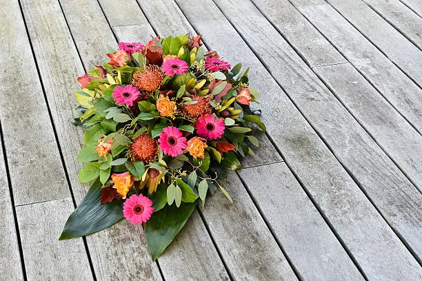 Funeral theme with flower creation in drop shape.