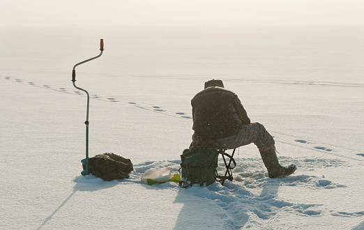Ice fishing on the lake. Winter season
