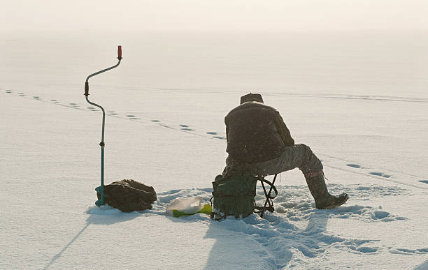 Ice fishing on the lake. Ice fishing on the lake. Winter season man ice fishing stock pictures, royalty-free photos & images