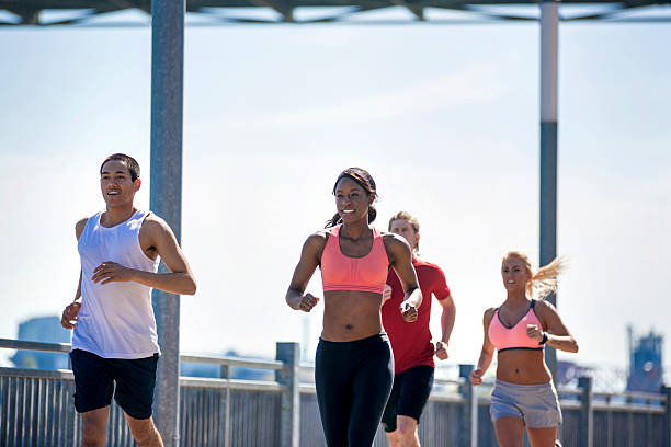 istock Group of diverse co-ed athletes jogging together 619078478
