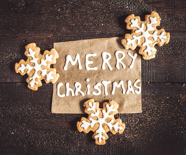 istock Christmas gingerbread cookies and inscription on a dark backgrou 619078698