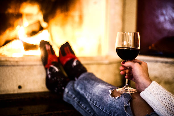 istock Glass of red wine by the fire place 619079358