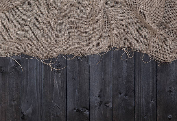 istock Burlap or sack on dark wooden background 619081052