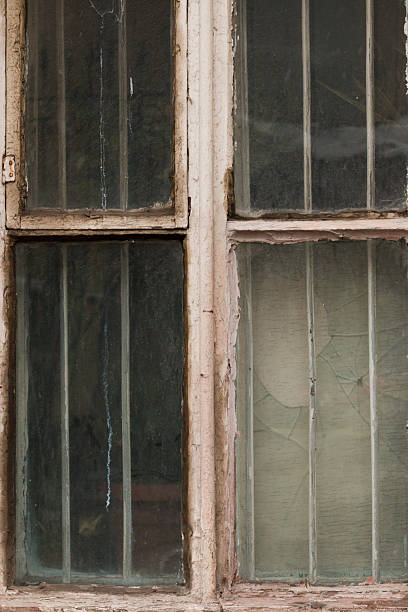 istock Old cracked and Broken Window in an industrial mill. 619081222