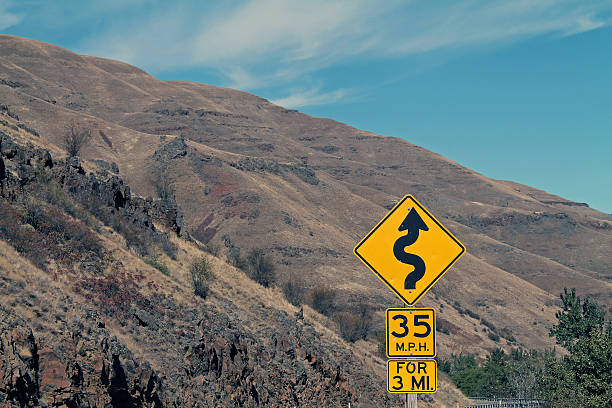 istock Road Sign on Curving Mountain Road in eastern Oregon, USA 619081330