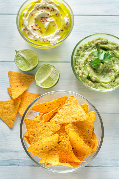 istock Bowls of hummus and guacamole with tortilla chips 619081598