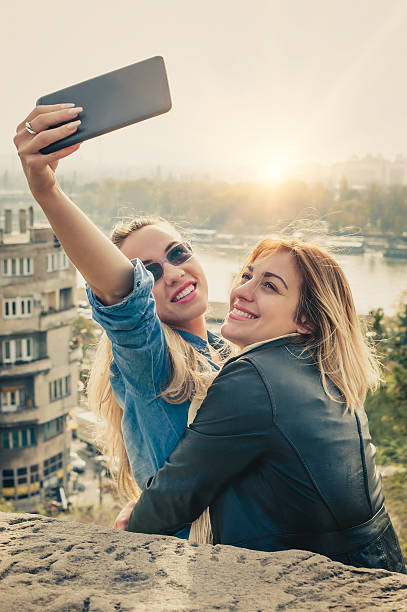 istock Two beautiful friends funny selfie on a tablet 619083014