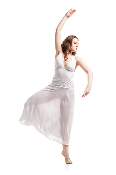 istock Young woman dancing in dress over white 619083110
