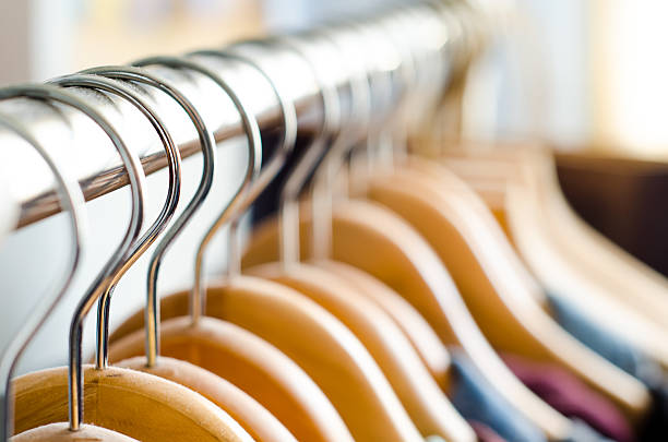 wooden hangers closeup of a lot of wooden hangers clothes hanger rod stock pictures, royalty-free photos & images