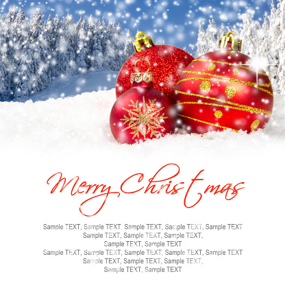 Photo of red Christmas ball group with falling snow and white space for text