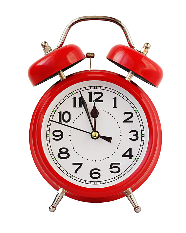 Red retro alarm clock at twelve o'clock, isolated on white background. Midnight, midday. Minutes about New year.