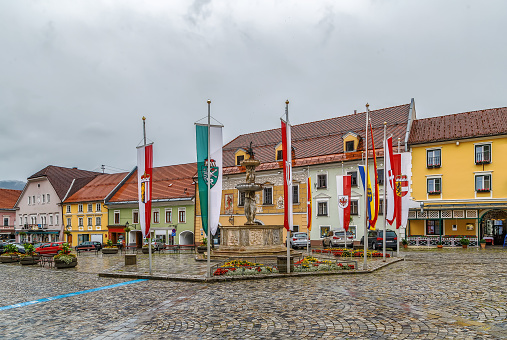 Main square with fountain and historical houses, Friesach, Austria