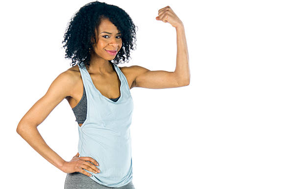 istock female model attractive woman showing strength with arm curl 619086552