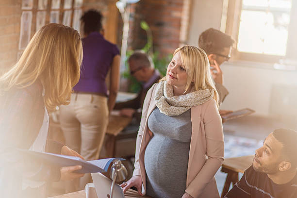 istock Pregnant manager talking to her employees 619086582