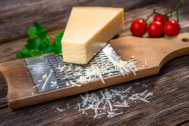 istock Grated parmesan cheese and  grater on wooden background 619087306