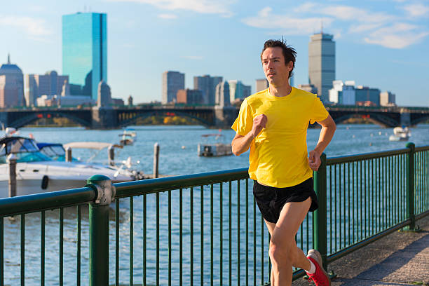 Runner in front of Boston's Skyline Runner in front of Boston's (USA) skyline in the morning. You can see the Longfellow Bridge crossing Charles river as well as some skyscrapers like the Prudential Tower. prudential tower stock pictures, royalty-free photos & images