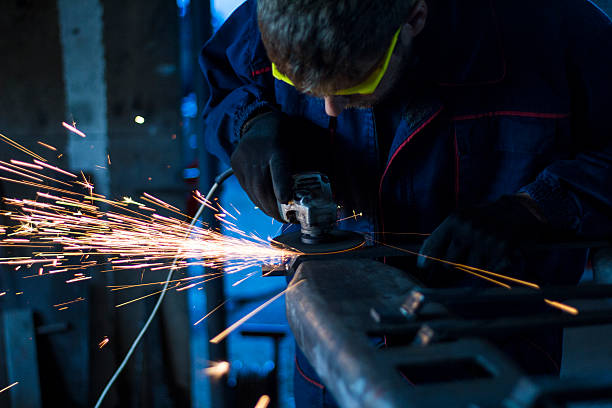 istock Factory worker using electric grinder in METAL INDUSTRY. 619088372