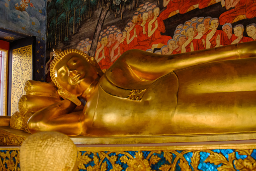 Reclining Buddha gold statue and thai art architecture in Wat Bovoranives, Bangkok, Thailand. Photo taken on: October 30, 2016  .