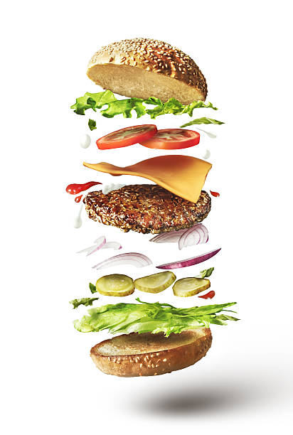Delicious hamburger with flying ingredients Delicious hamburger with flying ingredients on white background floating on water stock pictures, royalty-free photos & images