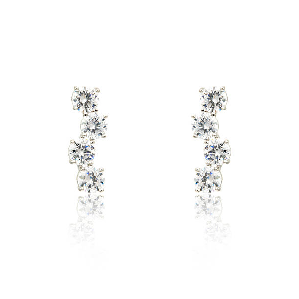 istock Pair of silver diamond earrings isolated on white 619088718
