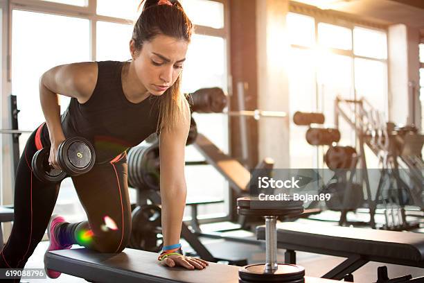 Fitness Girl Lifting Dumbbell In The Morning Stock Photo - Download Image Now - Gym, Health Club, Exercising