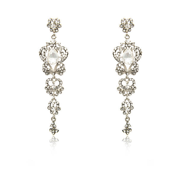 istock Pair of silver diamond earrings isolated on white 619090486