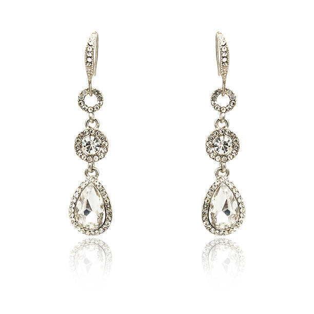 istock Pair of silver diamond earrings isolated on white 619091434