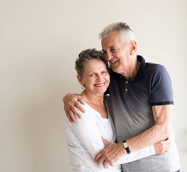 istock Older couple with arms around each other 619228650