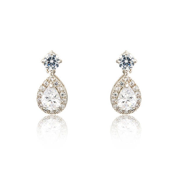 istock Pair of silver diamond earrings isolated on white 619228940
