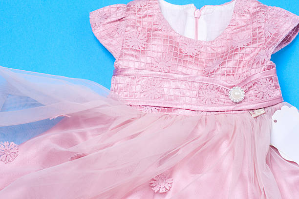 istock Clothes for baby girl on a pink background. Copy space 619229196