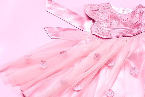 istock Clothes for baby girl on a pink background. Copy space 619229236