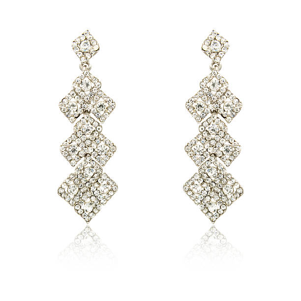 istock Pair of silver diamond earrings isolated on white 619229424